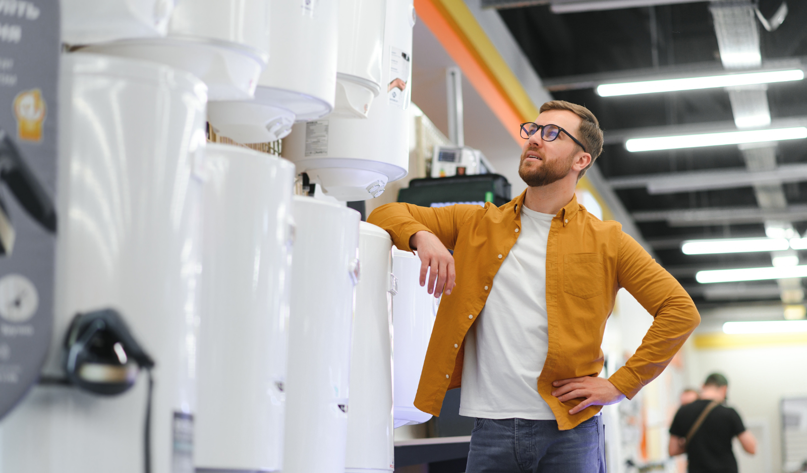 Client care alege un boiler electric pentru montaj, într-un magazin de specialitate